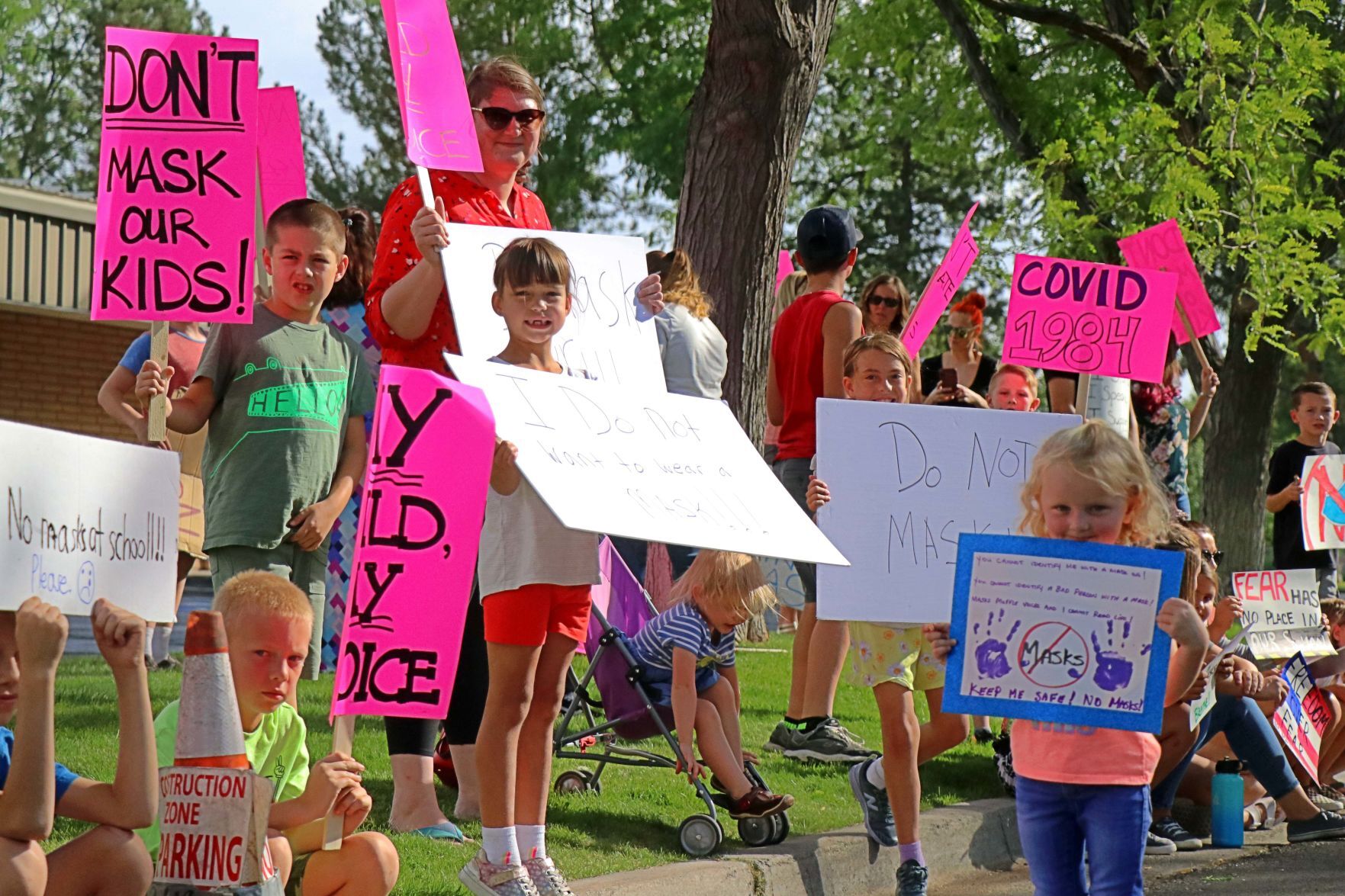 Face mask protest signs held by children and parents